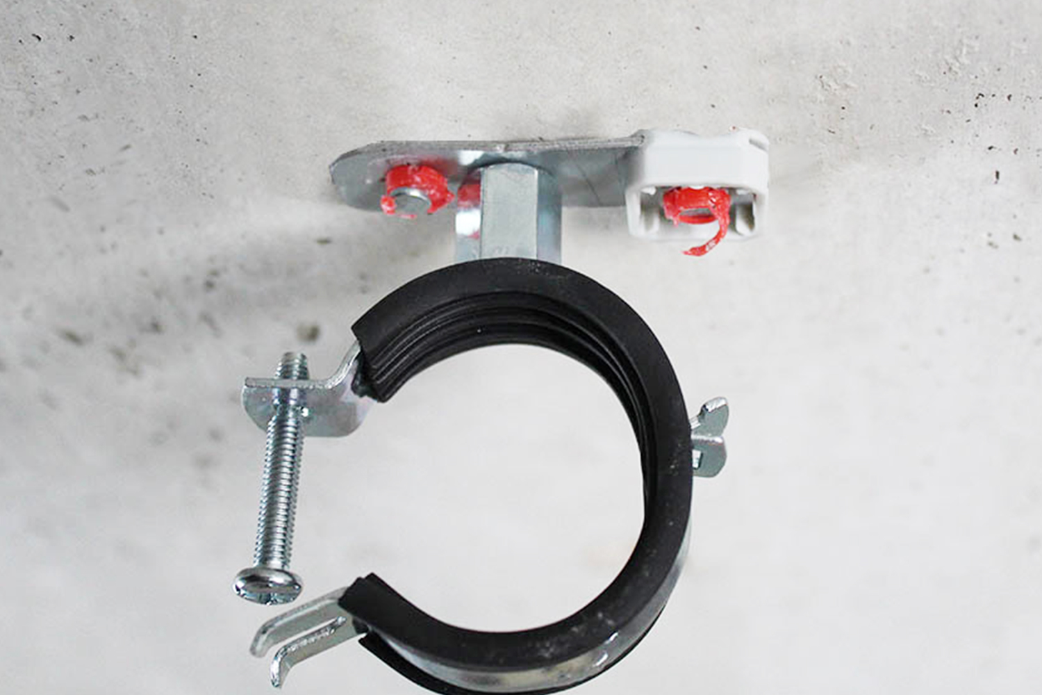 Imagen de aplicación del colgador de abrazadera ATR: ATR montado en un techo de hormigón, con una abrazadera metálica en su rosca métrica